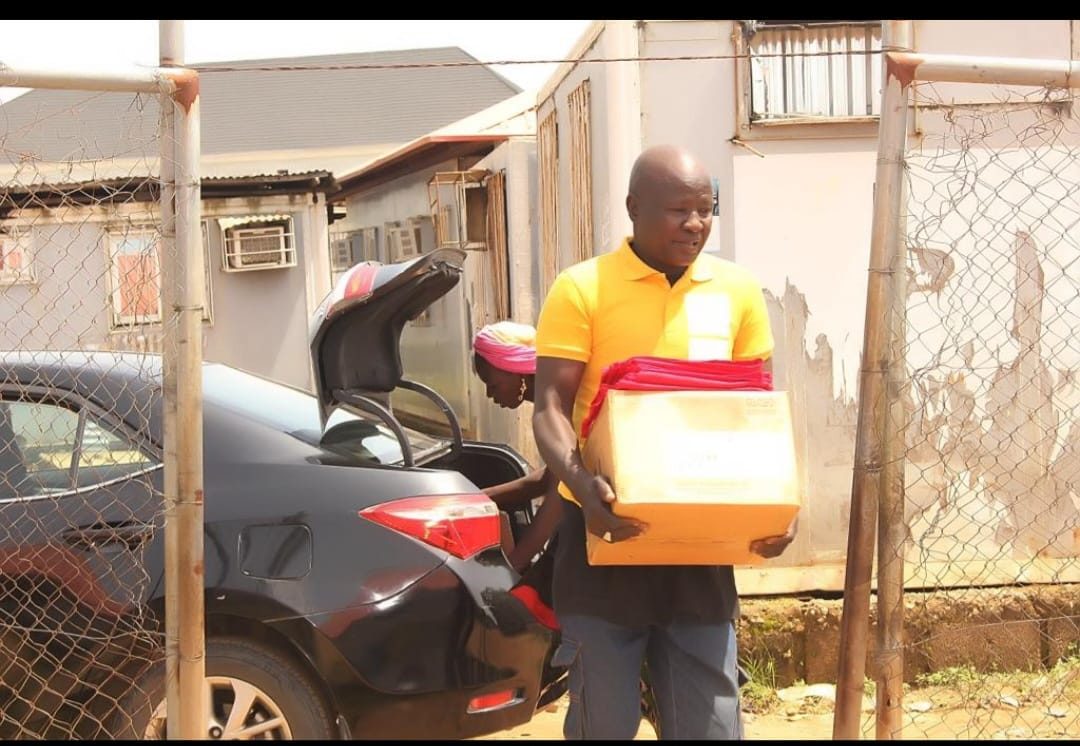 Boxes of books being carried in for the New Kuchigoro outreach.